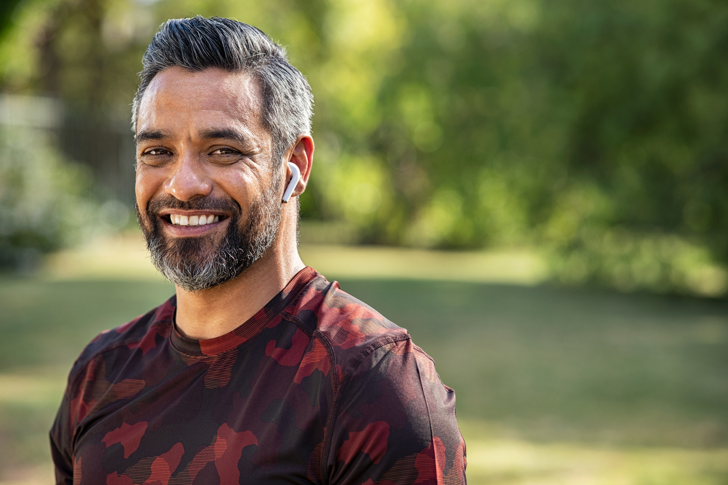 Smiling Man Wearing Wireless Earphones 